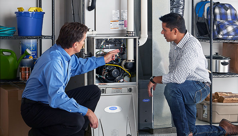 HVAC technician evaluating a furnace for repair or replacement in Sandy