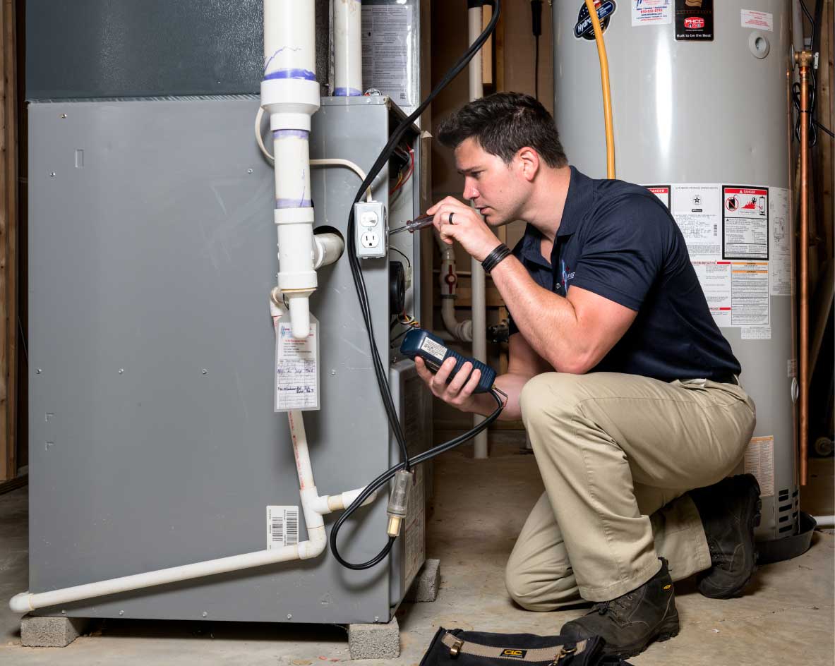 HVAC technician performing a furnace tune-up in Sandy