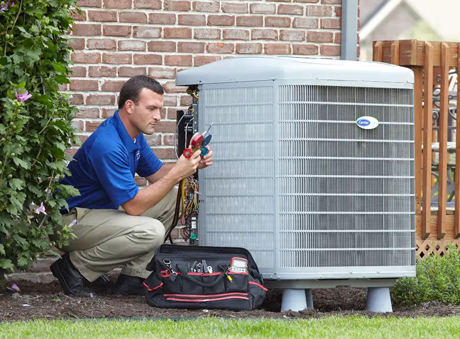 HVAC technician inspecting an outdoor air conditioning unit in Sandy