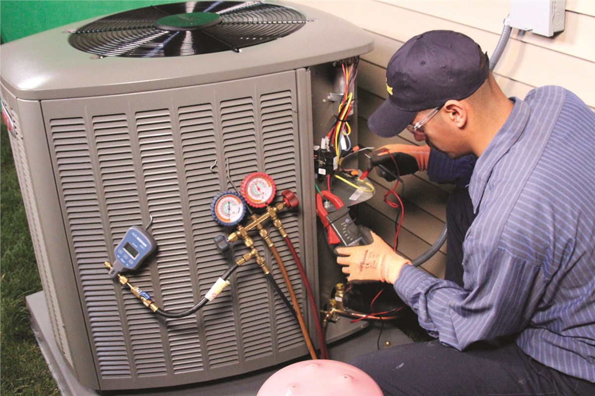HVAC technician testing an outdoor air conditioning unit in Sandy